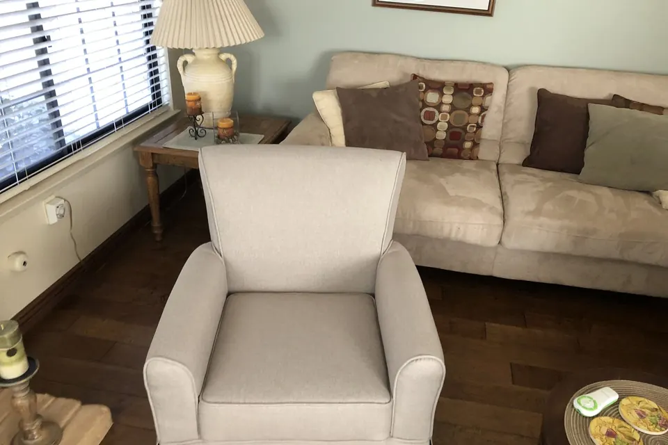 Cream upholstered armchair assembled in a living room
