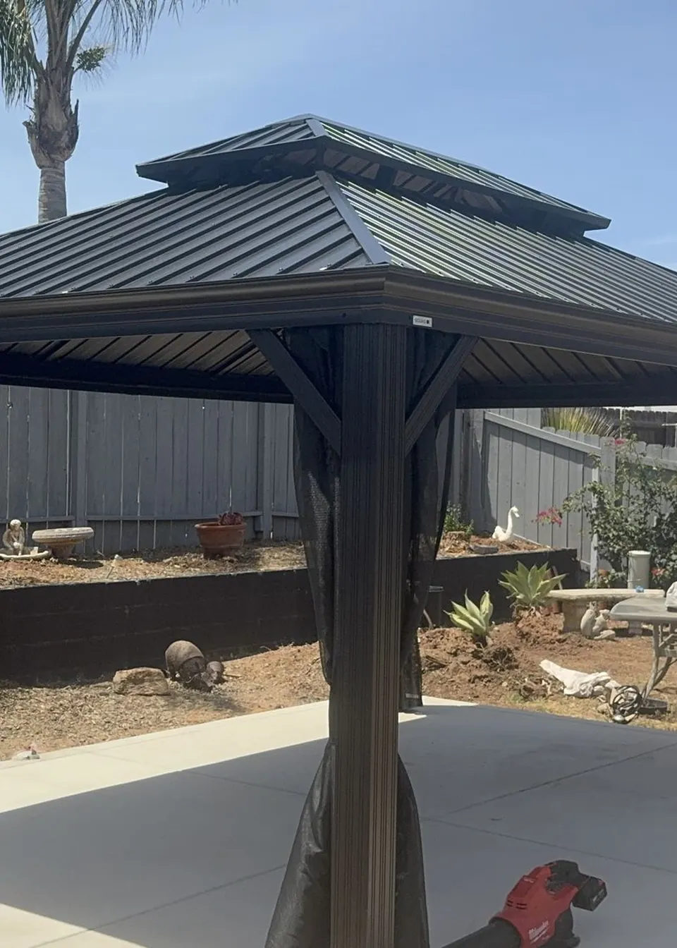 Finished hardtop gazebo with privacy curtains in a San Diego backyard