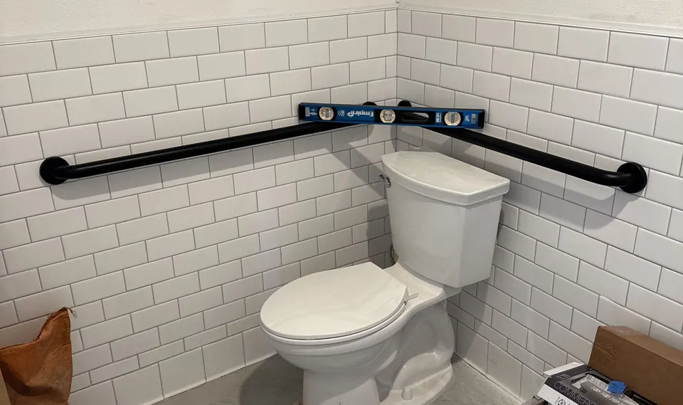 Handyman grab bar installation beside a toilet in San Diego