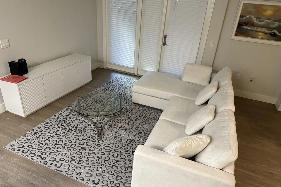 White sectional sofa and storage bench assembled in a living room