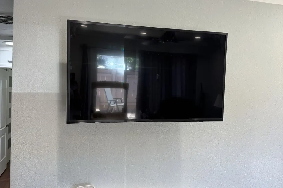 Flat-screen TV mounted on the wall above a console